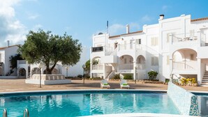 A swimming pool with white buildings in the background. - CASTELLSOL 201 (Arenal d´en Castell)