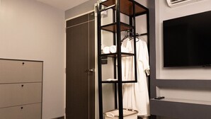 A room with a wardrobe, a television, and a laundry basket. - Cabanaz Pool Villa (Bangkok)