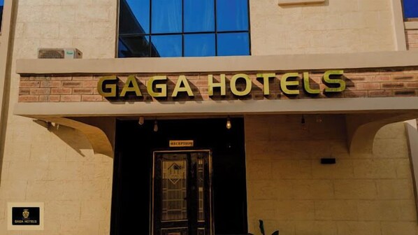 The exterior of GAGA Hotels with a reception area and a sign indicating the entrance. - GAGA HOTELS (Enugu)