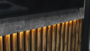 A close-up of a wooden slat wall with a black panel above it. - Cosy apartment for 4 people with WIFI and TV (Jindrichuv Hradec)