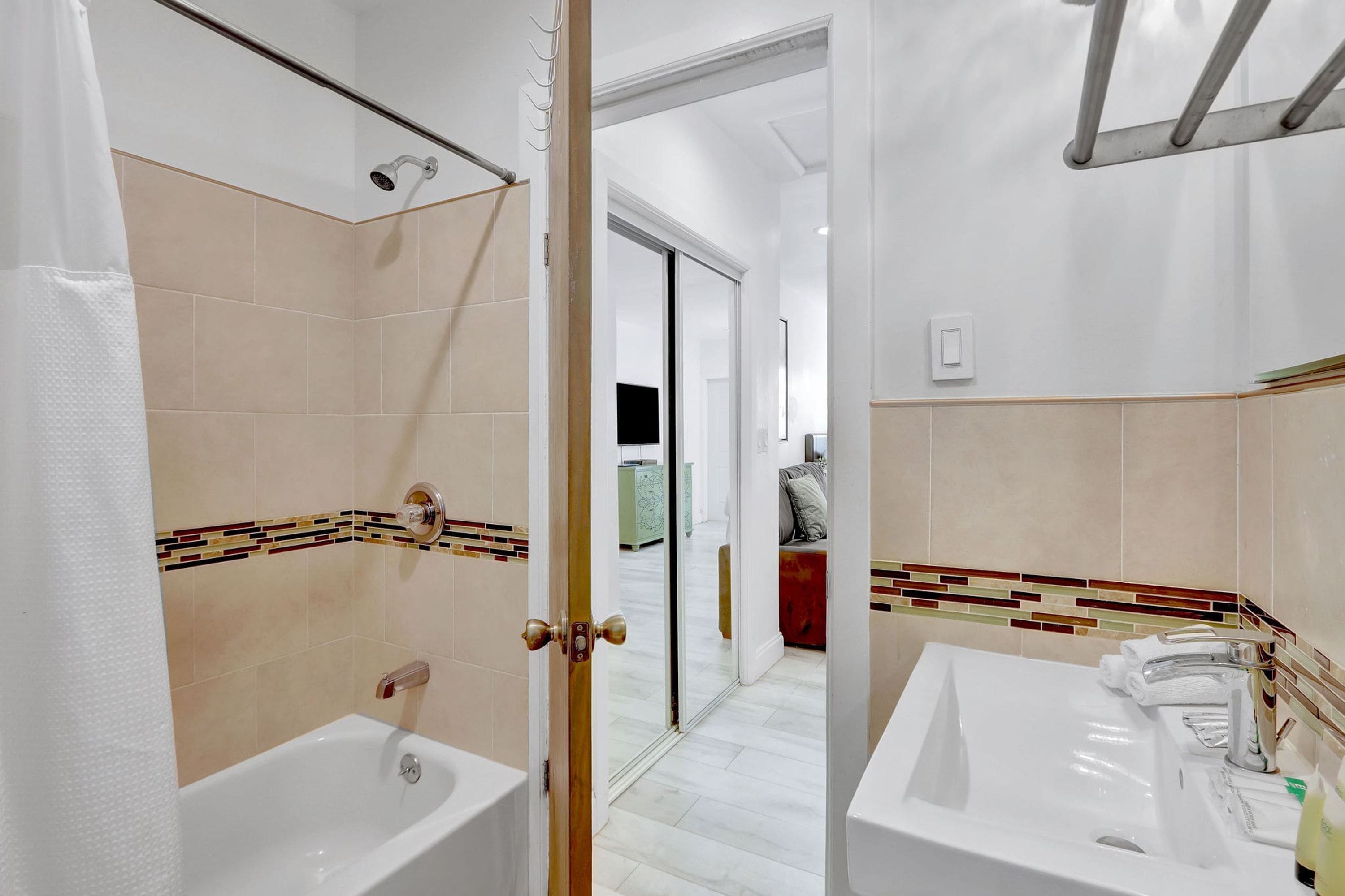 A bathroom with a bathtub, a sink, and a shower.
