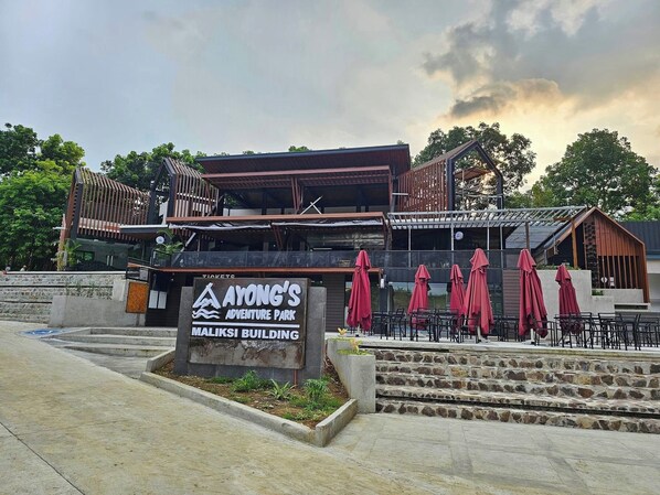 A building with a sign for Ayong's Adventure Park and Maliksi Building.