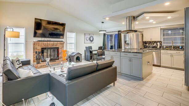A modern kitchen with a built-in stove, stainless steel appliances, and a large island. - 2 Mi to Golfing: Chic & Cozy Retreat in Lakeland! (Lakeland)