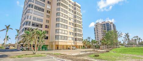 A multi-story hotel with a modern design, featuring balconies and large windows.