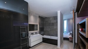 A modern bathroom with a large bathtub, a double sink vanity, and a walk-in shower. - Ethereal 4bed Camps Bay Villa Atlantic Reflection (Cape Town)