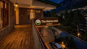 A hotel with a balcony, wooden flooring, and a sign reading 'The Nature Crest Manali'. - The Nature Crest Manali (Manali)