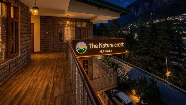 A hotel with a balcony, wooden flooring, and a sign reading 'The Nature Crest Manali'. - The Nature Crest Manali (Manali)