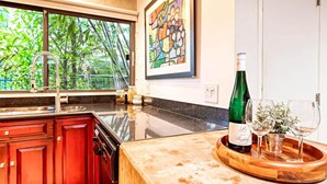 A kitchen with a large window, a sink, and a wooden countertop. - Piano House on the Water (Fort Lauderdale)