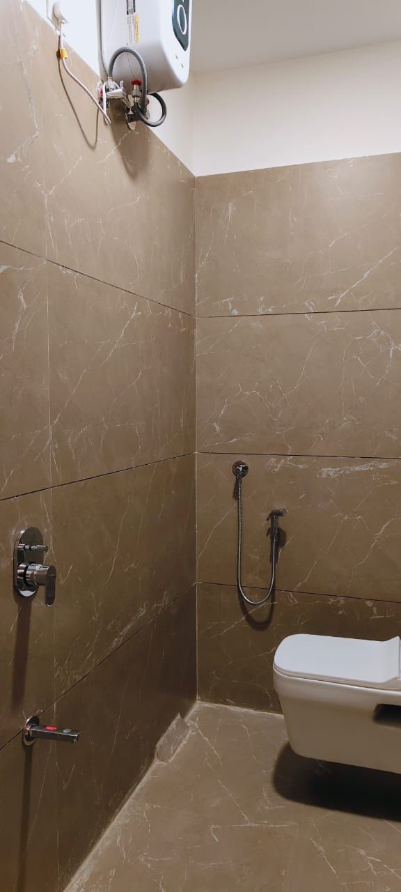 Un baño con ducha, inodoro y toallero.