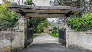 A gated entrance with a covered walkway leading to a building.