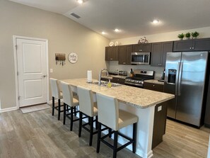 Fridge, microwave, oven, stovetop - Stylish home with gourmet kitchen, dual garages, and private golf cart! (Okahumpka)