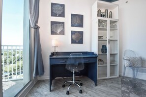 A corner office with a desk, chair, and shelving unit. - 10th Floor Condo w/ Lagoon-Style Pool at The Palms of Destin! π΄ππ (Destin)
