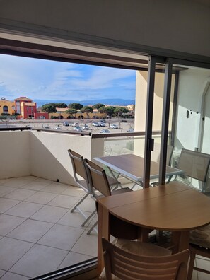 Enjoy a balcony with a table and chairs, offering a view of the surrounding area.