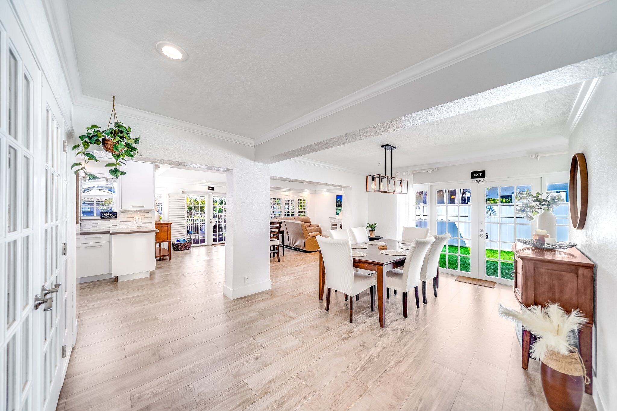 A spacious, well-lit interior with a dining area, kitchen, and open-plan layout.