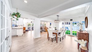 A spacious, well-lit interior with a dining area, kitchen, and open-plan layout. - Heated Pool! Waterfront+Kayak! Close 2 Beach! (Pompano Beach)