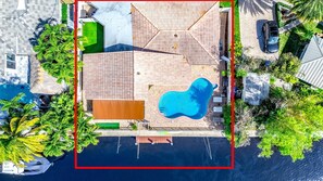 An aerial view of a property with a swimming pool, a covered patio, and a boat dock. - Heated Pool! Waterfront+Kayak! Close 2 Beach! (Pompano Beach)