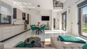 A modern kitchen with a dining area, large windows, and a staircase. - Villa Dide moga ZadarVillas (Sveti Petar)