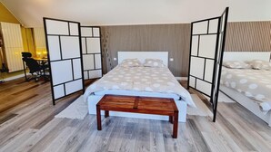 A bedroom with a bed, a wooden bench, and a desk with a chair. - LA GRANGE AU CORPS (Gussignies)