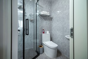 Shower, towels, soap, toilet paper