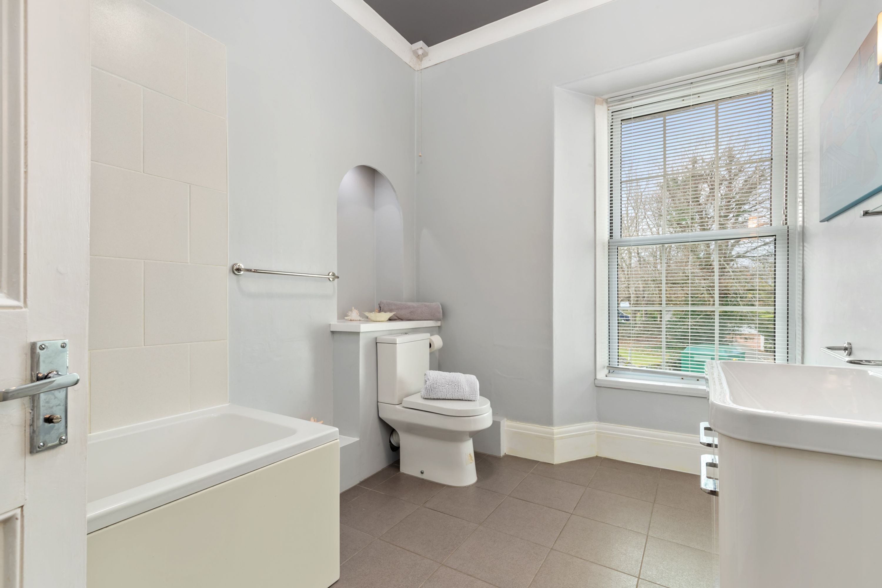 A bathroom with a bathtub, toilet, and sink.