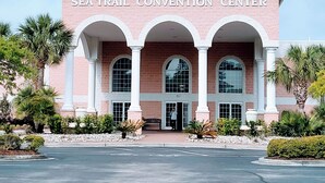 The Sea Trail Convention Center with a brick facade, arched entrance, and columns. - 2 BR 2 BA Royal Poste condo in Sea Trail Resort Sunset Beach, NC (Sunset Beach)