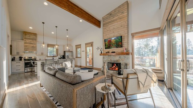 A spacious living area with a fireplace, a large TV, and a view of the outdoors. - Wilderness Club Cabin Sleeps 7 (Eureka)