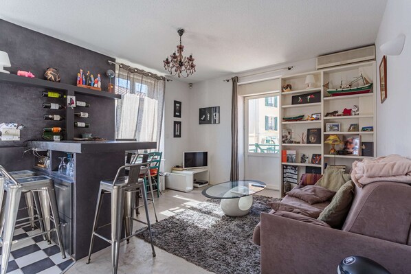 Un salon moderne avec un coin bar, un canapé et une table basse.