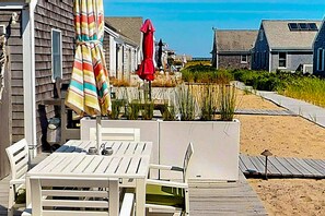 Outdoor dining - Quiet cottage on the beach with deck, grill, AC, & water views (Truro)