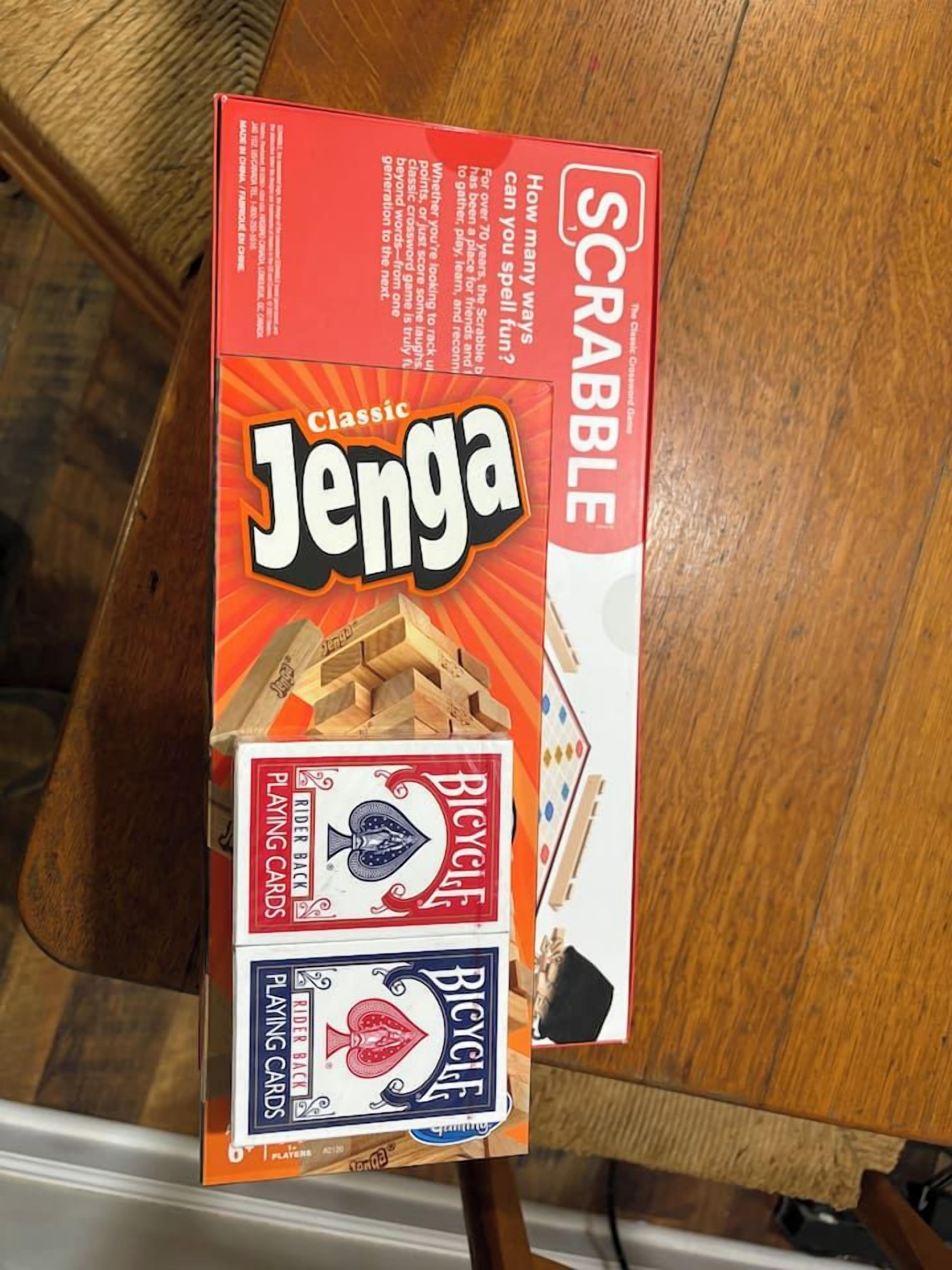 A box of Scrabble Classic Jenga on a wooden table.