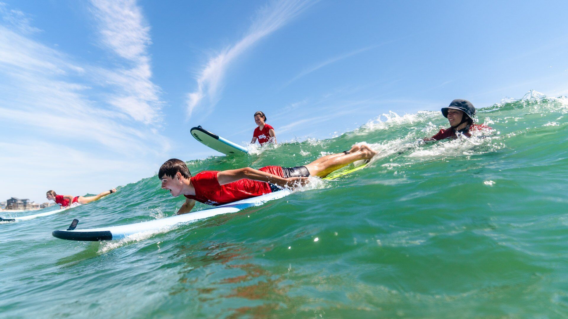 A group of people surfing on a wave.