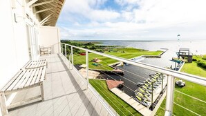 A balcony with a view of a marina and a grassy area. - Waterfront 3-Bedroom, 2.5-Bathroom Penthouse Suite at REAL Watersports (Waves)
