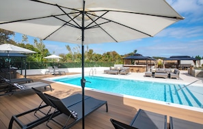 Outdoor pool, open 7:00 AM to 11:00 PM, pool umbrellas, sun loungers