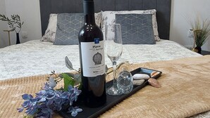 A neatly made bed with a headboard, a bedside table with a vase, and a framed picture on the wall. - Vacation apartment Happy Olive in Sevid near Trogir Croatia (Sevid na moru)