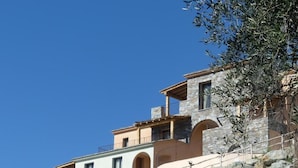 A multi-story stone building with a stone staircase leading up to the entrance. - DOMAINE SANTA MARGHERITA (Castellare-di-Casinca)