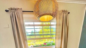 A cozy room with two chairs, a small table, and a window with curtains. - Zen 10, relax and retreat in the heart of Vermont (Manchester)