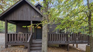 A rustic cabin with a wooden deck and a front door. - Jax Ridge-Studio 1 Bedroom (Broken Bow)