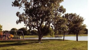A park with a playground, a bench, and a large tree. - ★Clean&Fresh★3BR/2BA★EZ access to S LBK/S Loop 289 (Lubbock)