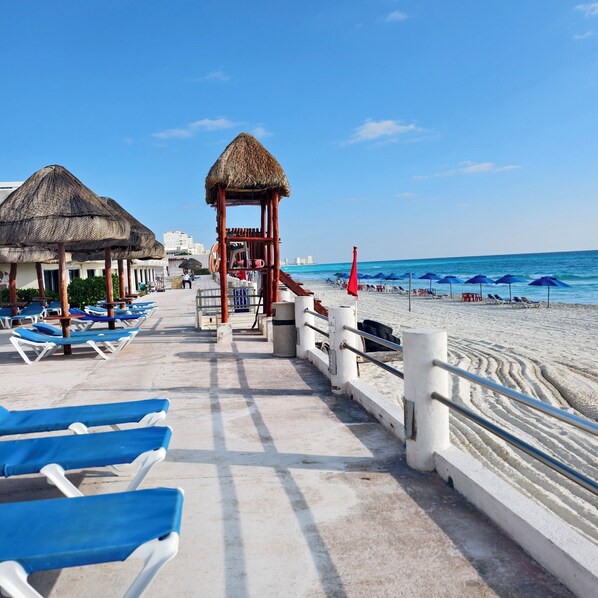 On the beach, sun loungers, beach towels