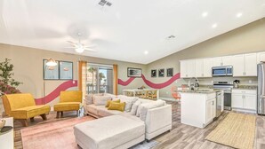 Un salon moderne avec un canapé, des fauteuils et un coin repas.