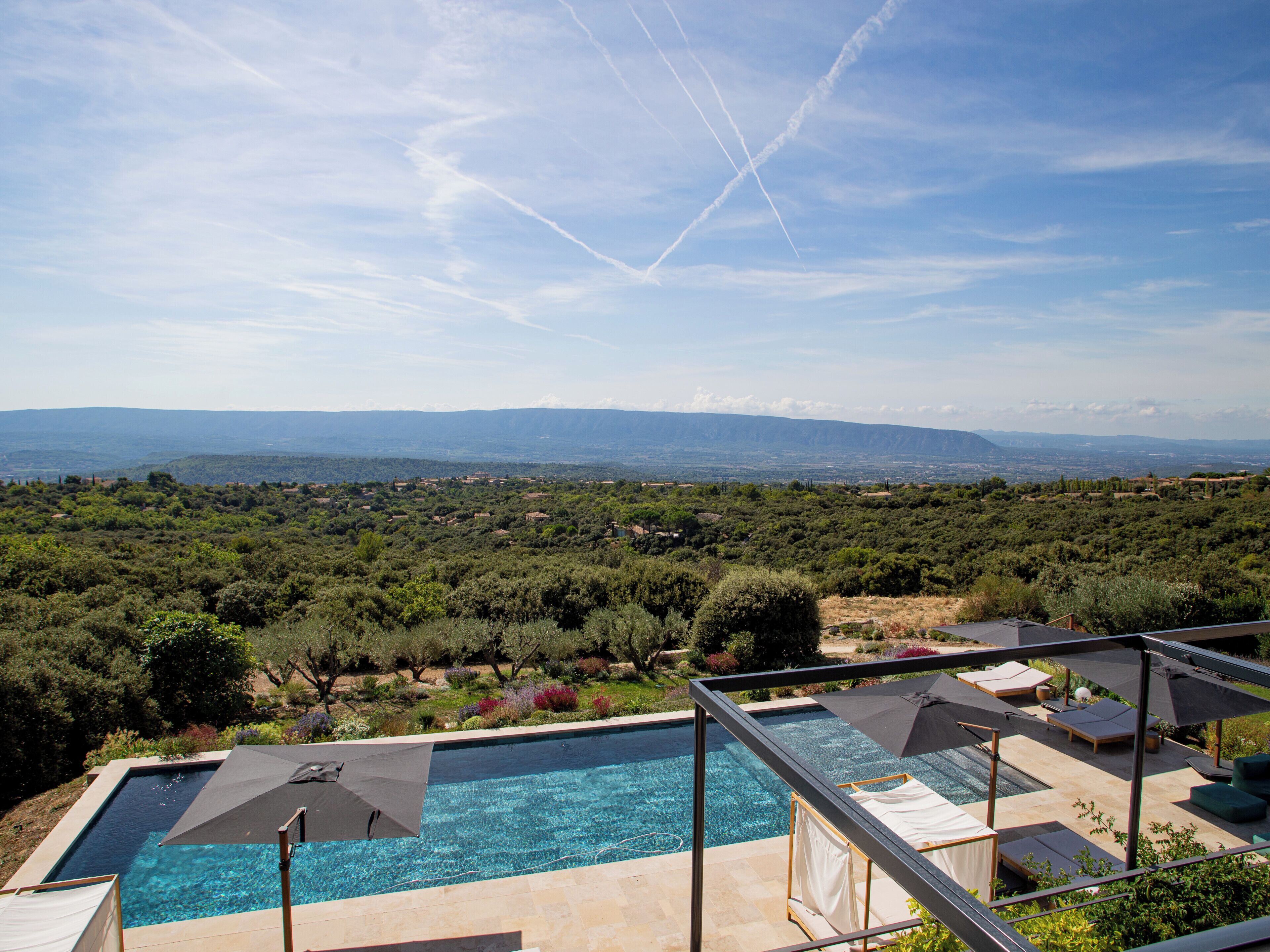 A swimming pool with a view of a mountainous landscape.