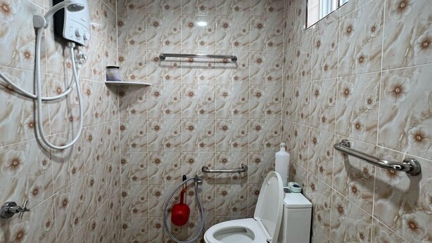 A small bathroom with a toilet, a shower, and a sink. - Capital O 91117 Noor Room Stay (Taiping)