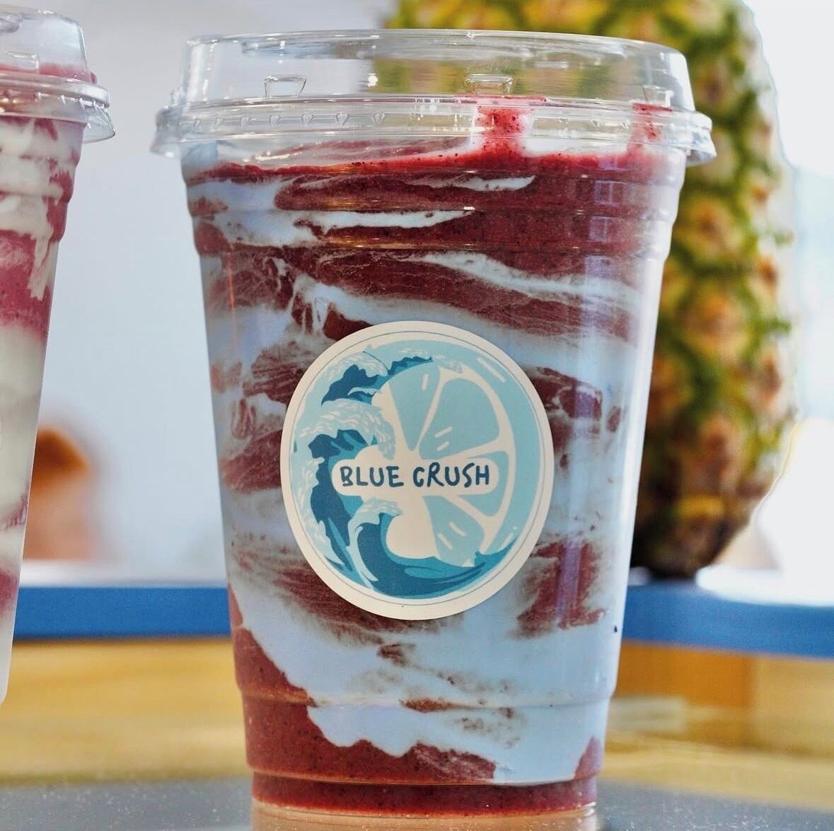 A beverage with a label reading 'Blue Crush' in a clear plastic cup.