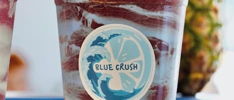 A beverage with a label reading 'Blue Crush' in a clear plastic cup.