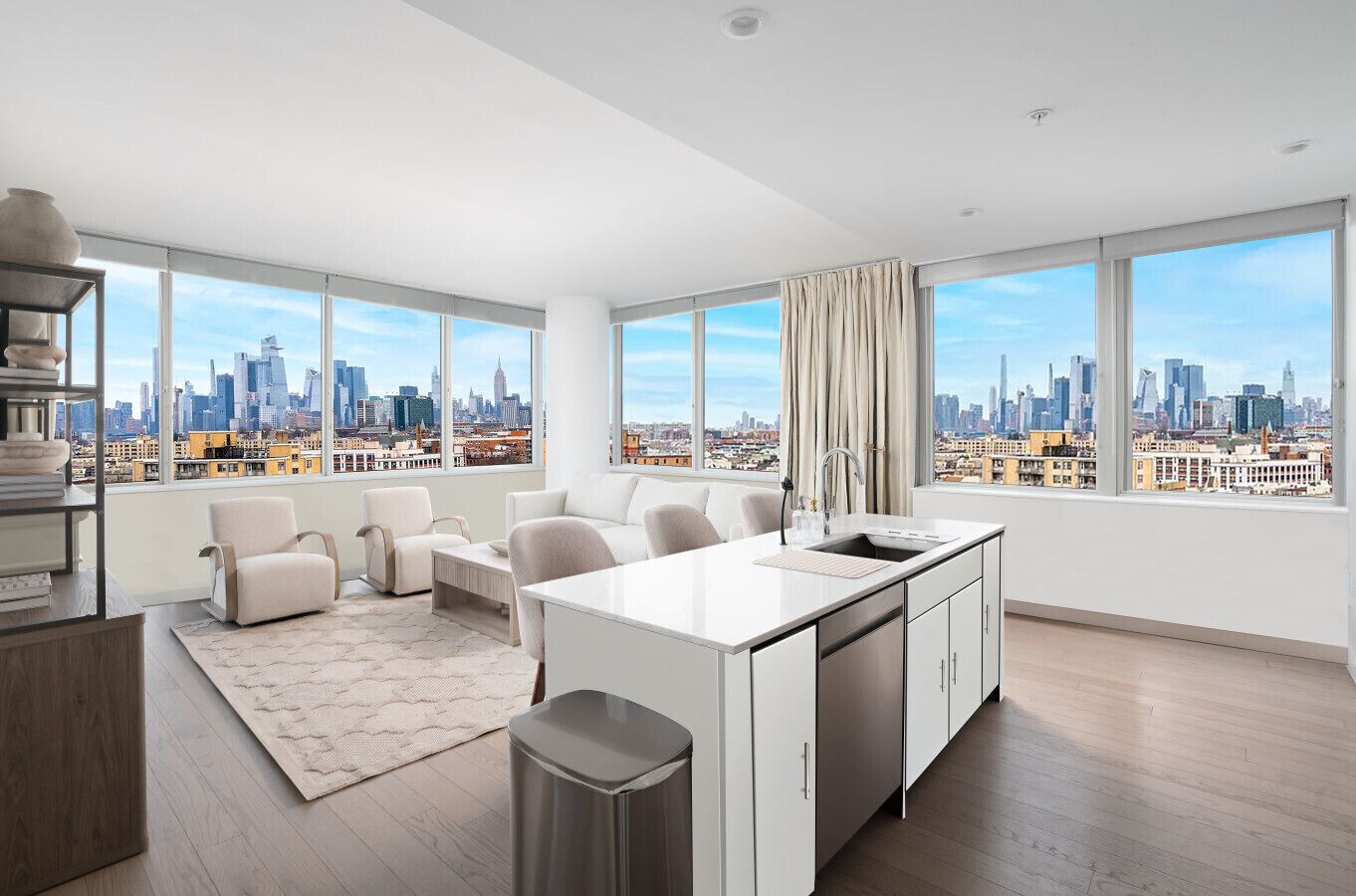 Una sala de estar moderna con vistas a la ciudad, una zona de cocina y un espacio para sentarse.