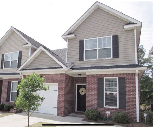 A two-story residential building with a brick facade, a front porch, and a garage. - Masters Golf Tournament Within 6 Miles - Convenient, Beautiful, Spacious (Augusta)
