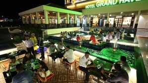 A hotel with outdoor seating and a fountain. - HOTEL GRAND HAVELI (Umargam)