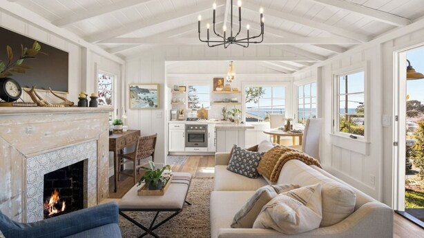 A spacious living room with a fireplace, a dining area, and a kitchen. -  Avail  this Dec 1st  2026. (Laguna Beach)