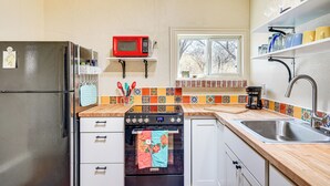 A kitchen with a refrigerator, microwave, oven, and sink. - Peaceful & Historic Home in Patagonia! (Patagonia)