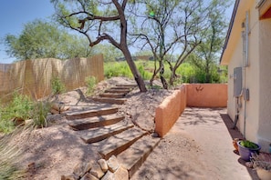 A set of stone steps leading up to a house with a fenced yard and a wooden fence. - Peaceful & Historic Home in Patagonia! (Patagonia)