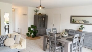 A dining area with a table, chairs, and a cabinet. - House for 6 people with a quiet garden in Les Sables d'Olonne (Les Sables-d'Olonne)